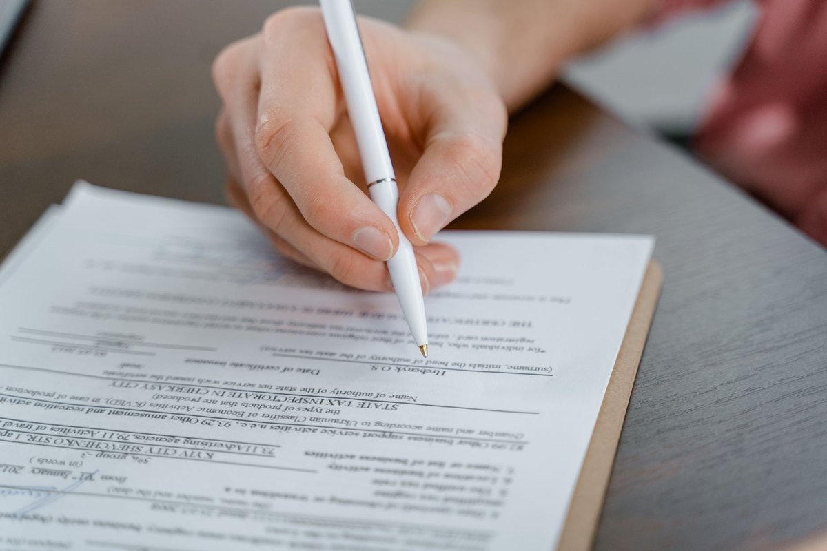 A document being signed by hand