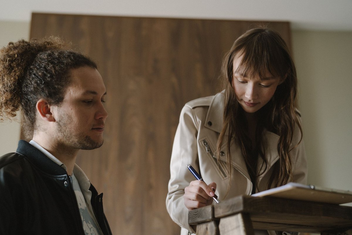 Two people signing a lease at a table