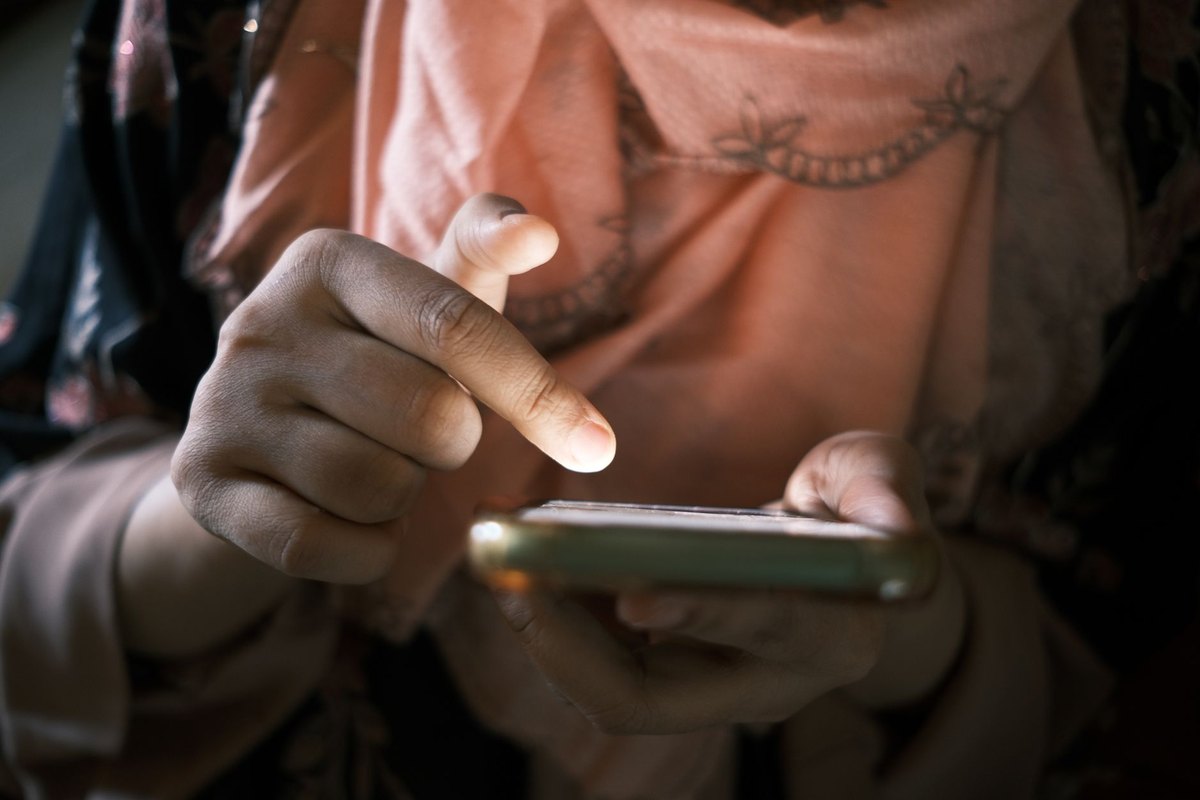 Hands using a smartphone interface