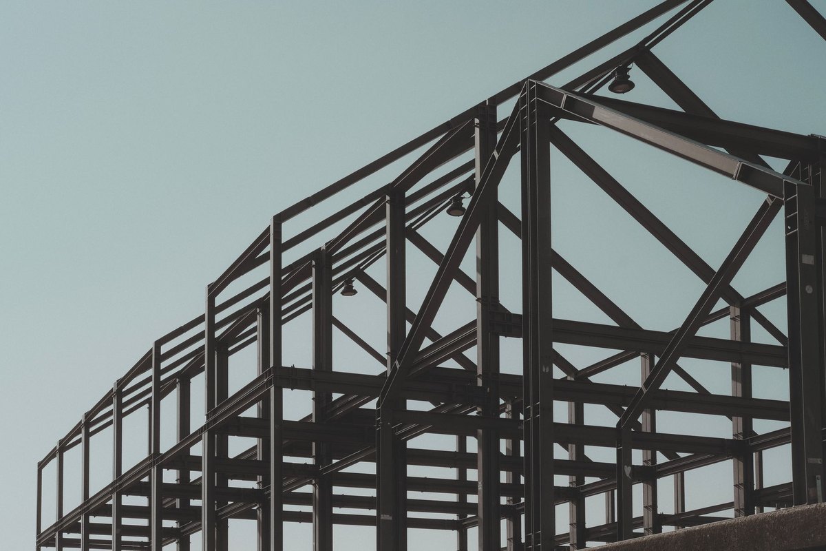 A steel construction framework rising against the sky